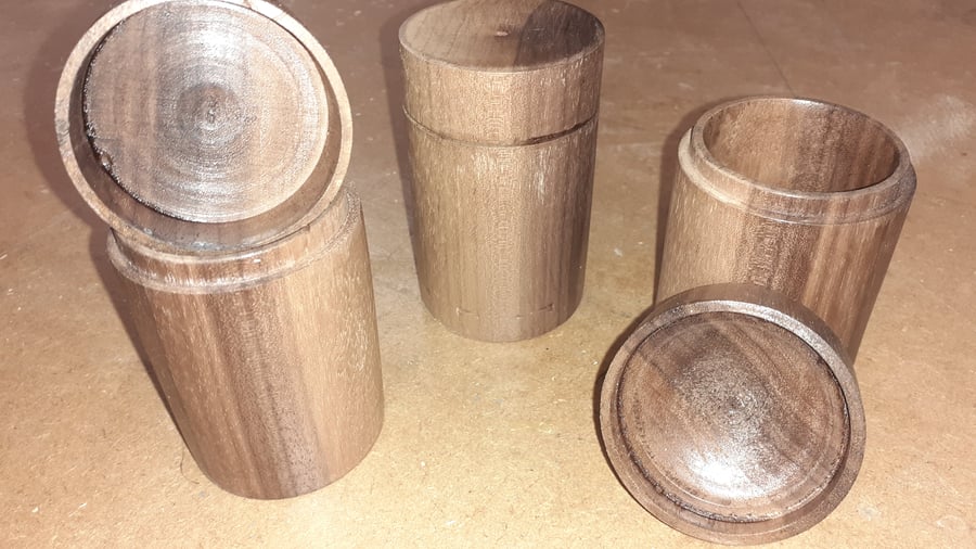 Three spice pots turned from a single length of solid walnut, app. 10 x 5 cm