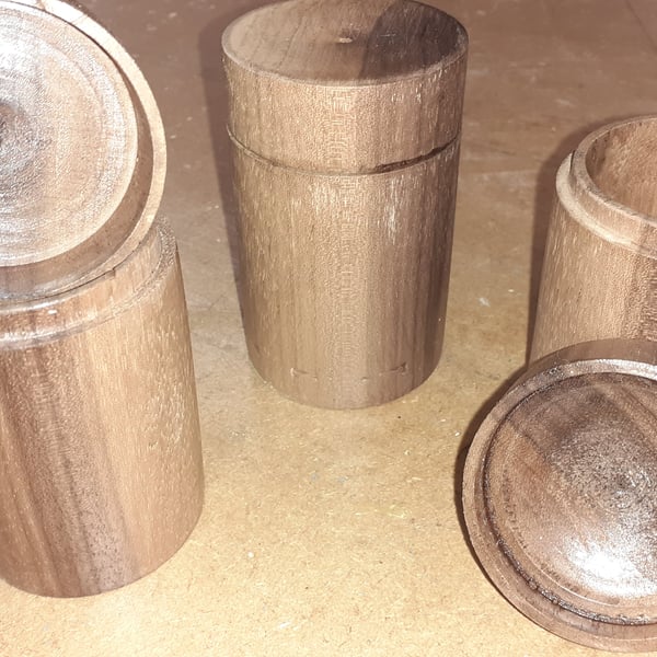 Three spice pots turned from a single length of solid walnut, app. 10 x 5 cm