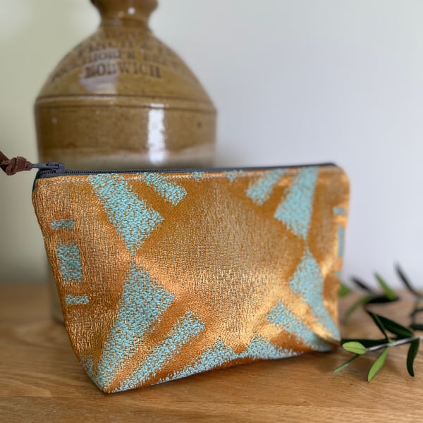 Copper and teal flat bottom zip pouch with ditsy floral lining 