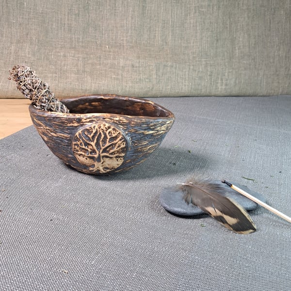 A bowl for smudging and plant arrangements with a tree of life relief medallion 