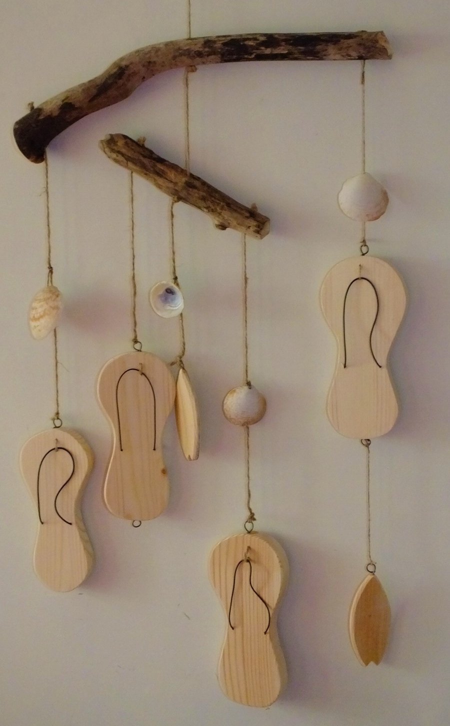 Driftwood mobile with flip flops, sea shells and surf boards ideal for summer.
