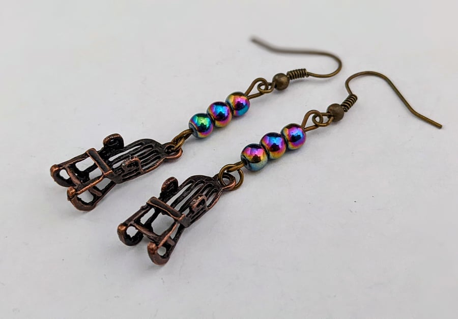 Bronze rocking chair earrings with rainbow Mardi Gras beads