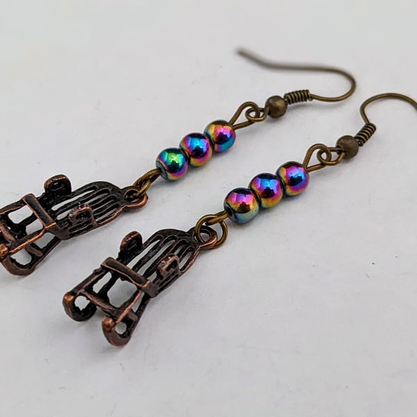 Bronze rocking chair earrings with rainbow Mardi Gras beads