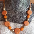 Handmade orange and gold swirl polymer clay disc necklace