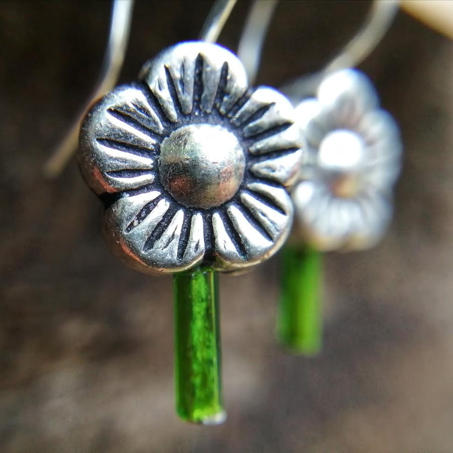 Dainty drop earrings with silver flower bead and green glass bead plant stem.