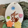 Pottery Easter Egg decoration with bunny in the flower meadow 