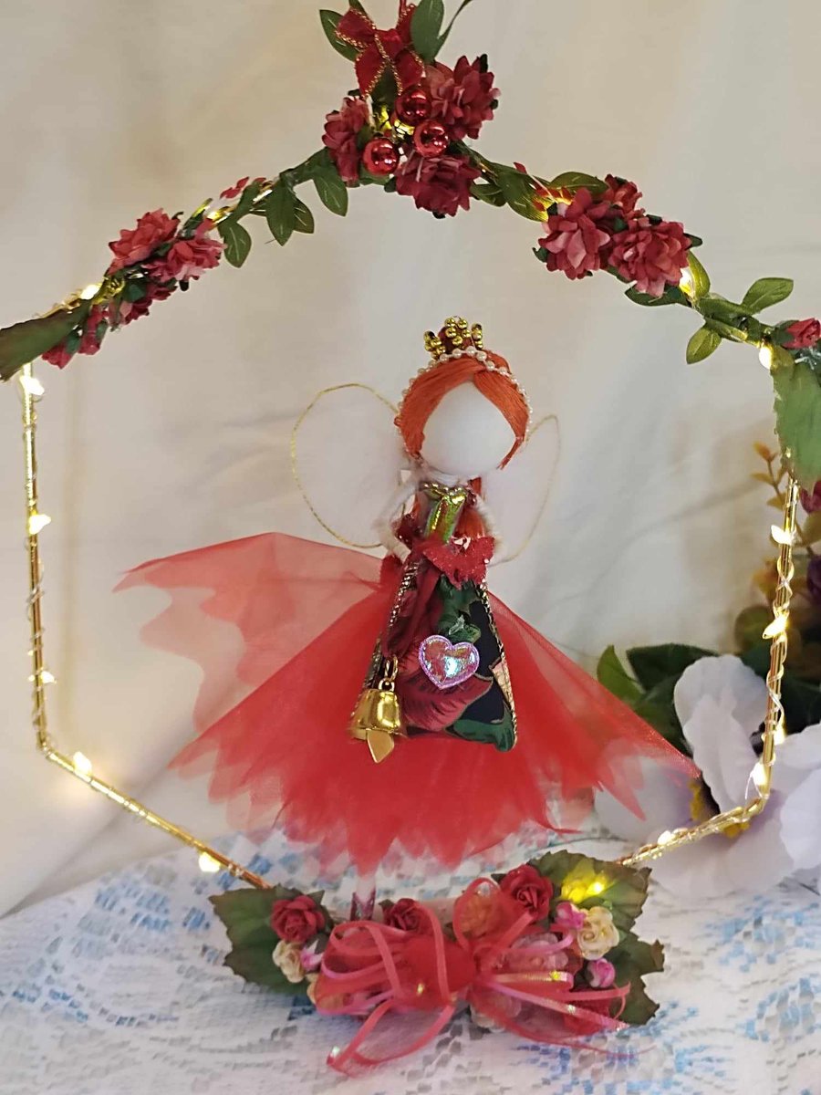 Handmade Red Fairy doll sitting on a hoop with fairy lights and flowers  