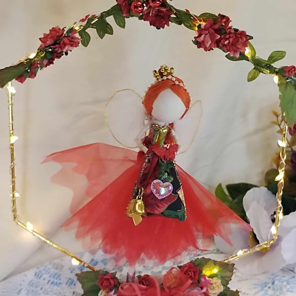 Handmade Red Fairy doll sitting on a hoop with fairy lights and flowers  