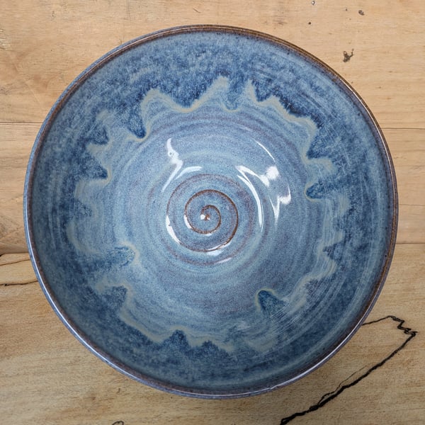 Medium to large sized pale blue wavy toasted bowl