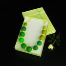 Handmade felt necklace green beads on ribbon presented in gift box.