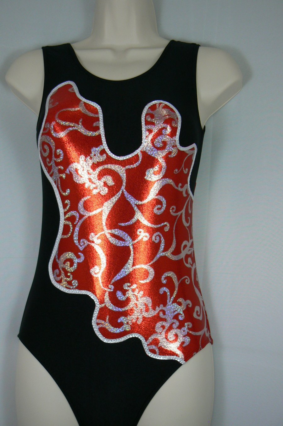 Black gymnastic leotard with red patterned sparkle