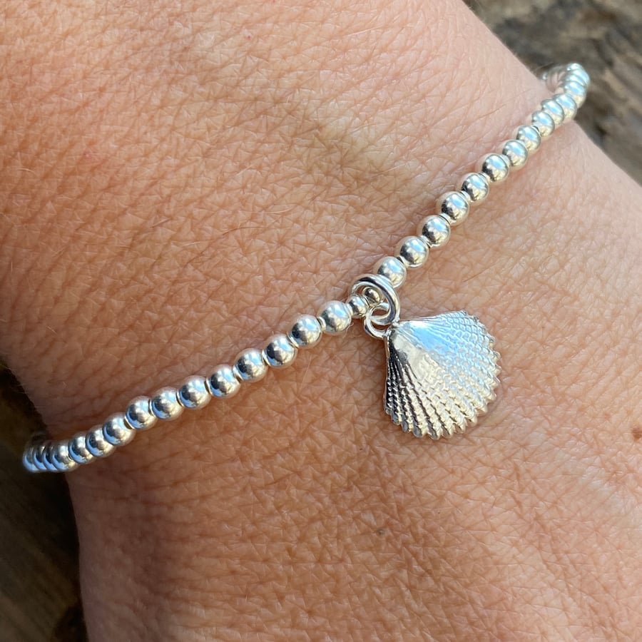Sterling silver bead bracelet with shell charm. Stretch bracelet. 