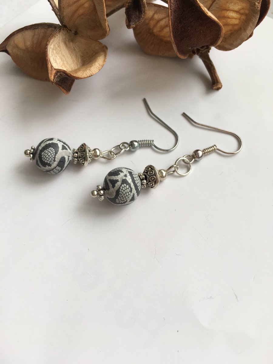 Cute dangle earrings with grey reptile effect polymer clay beads.