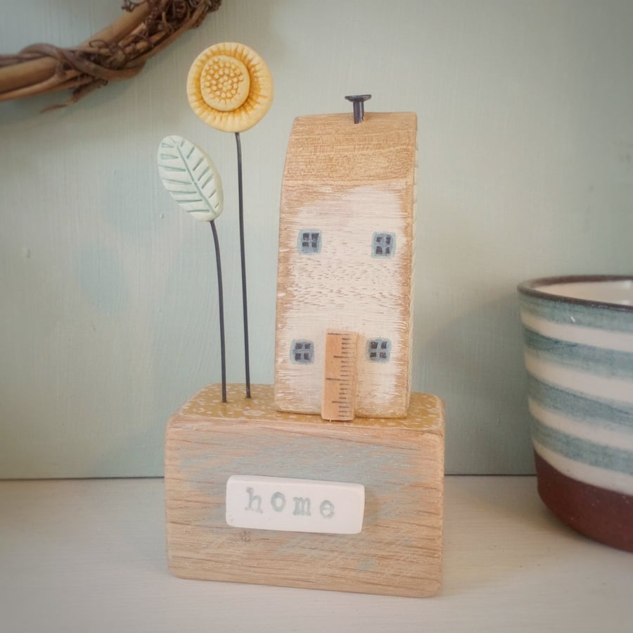 Little wooden house with sunflower garden 'home' 