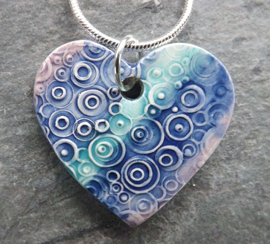 Heart shaped ceramic pendant in turquoise purple and blue