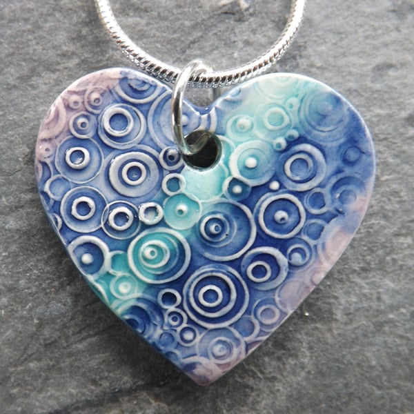 Heart shaped ceramic pendant in turquoise purple and blue