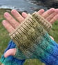 Hand knitted fingerless gloves featuring cable knit pattern