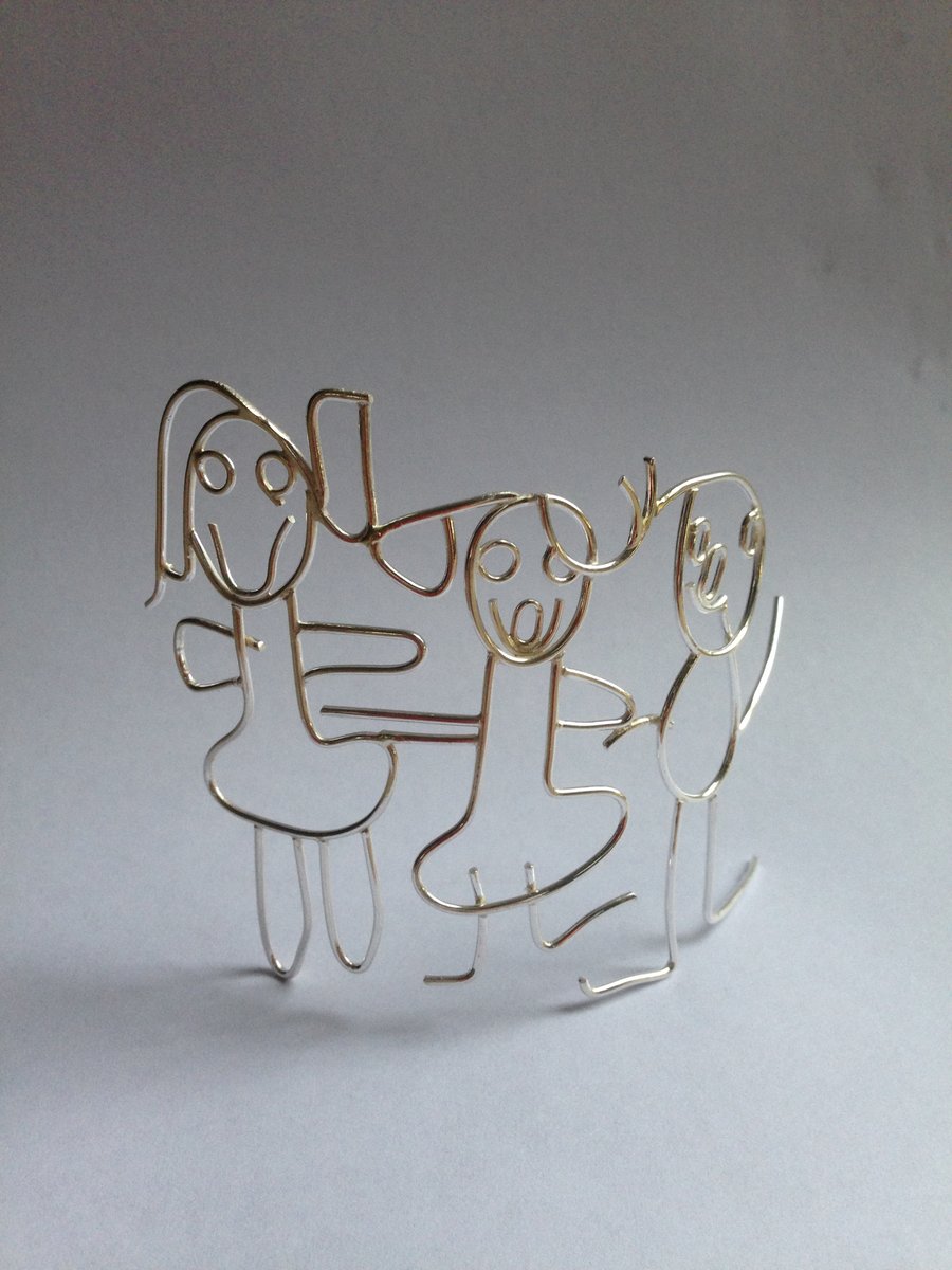 A freestanding Sterling silver family group from a childs drawing