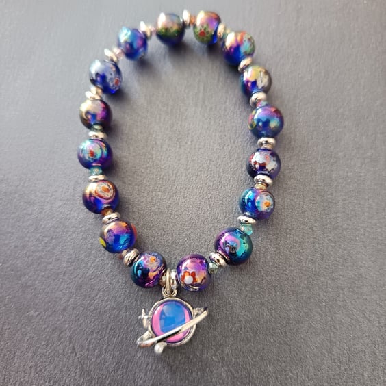 Elasticated celestial bracelet with blue-purple beads and planet charm