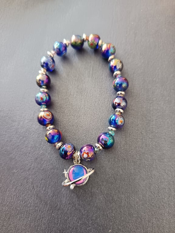 Elasticated celestial bracelet with blue-purple beads and planet charm
