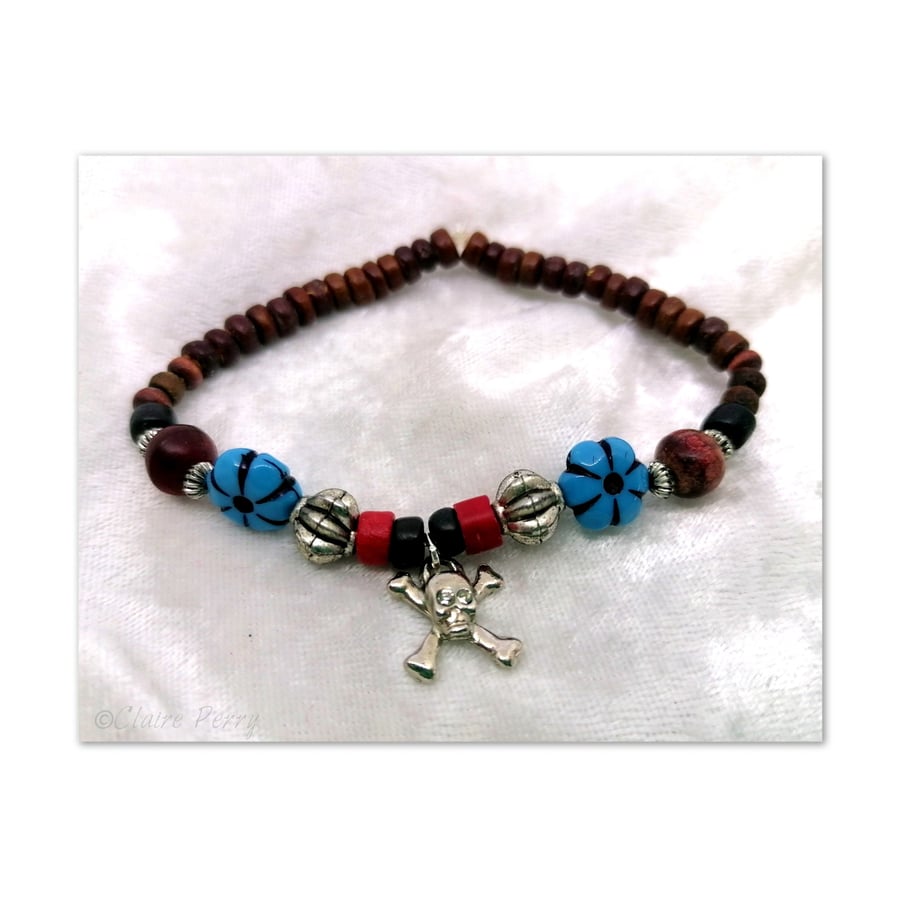 Wooden Surfer's bead bracelet with Turquoise bead, silver skull and crossbones.