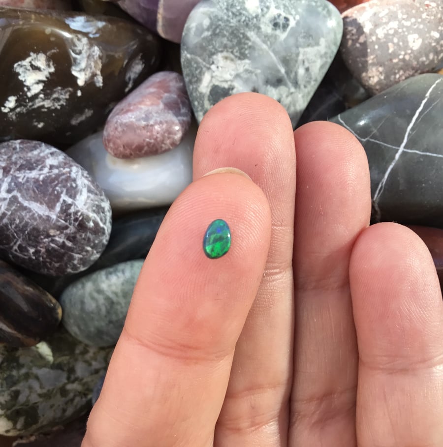 A beautiful Black Lightening Ridge Opal Cabochon with Green and Blue Fire.