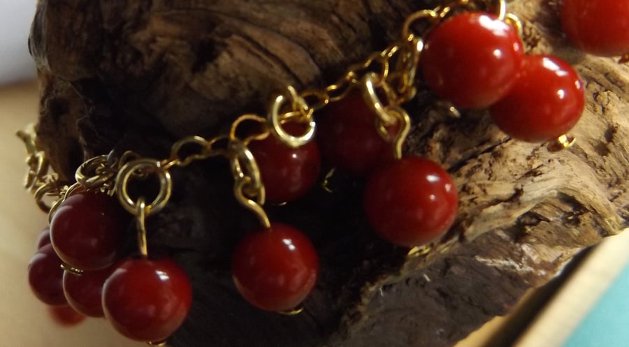 Red coral beaded bracelet with brass gold plated heart chain 