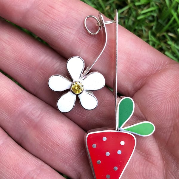 A strawberry flower and strawberry silver pendant with resin and gemstone