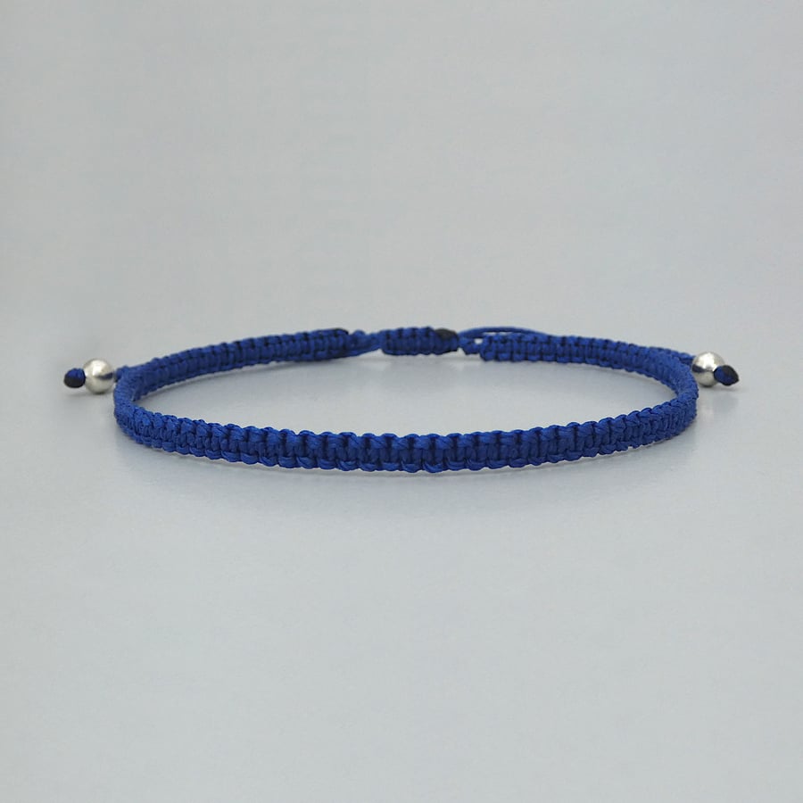 Blue macramé bracelet with silver plated bead ends. Extends from 7” to 9.5