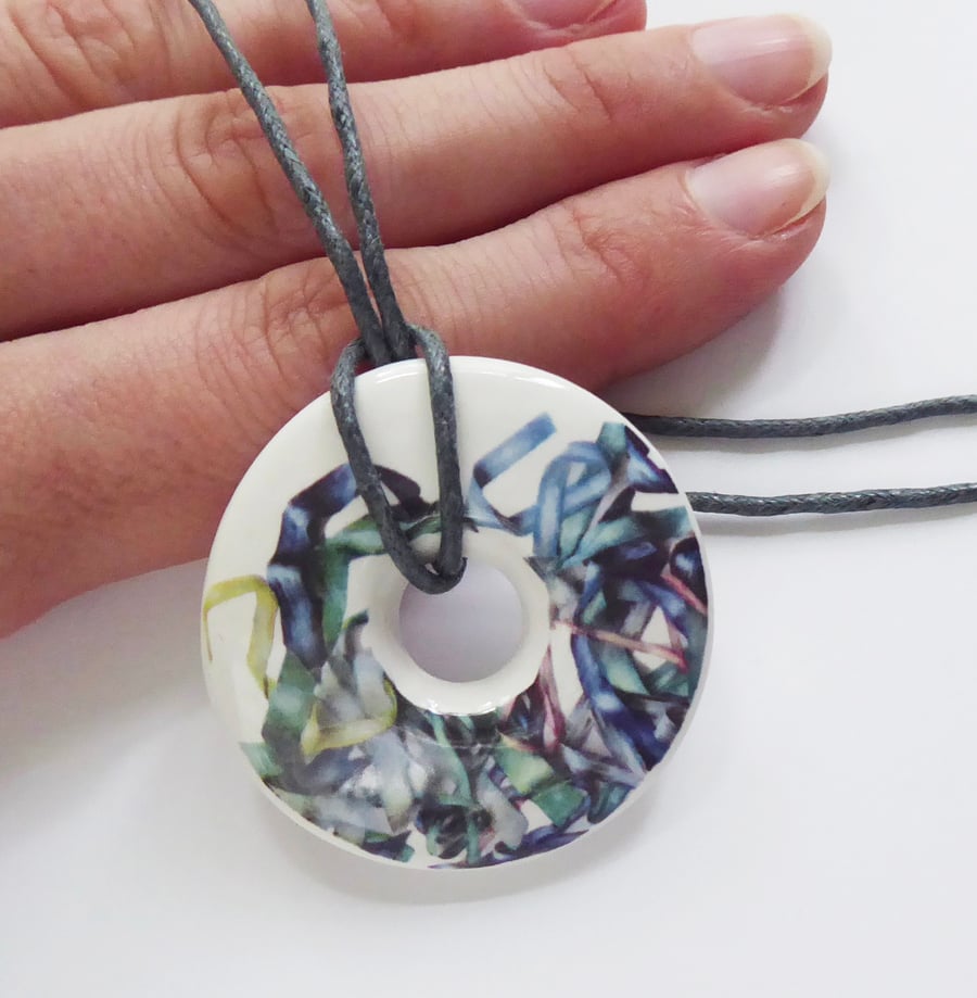 Tousled Ribbon Pattern Donut Shaped Ceramic Pendant on Grey Cord with Clasp