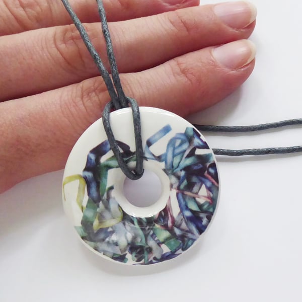 Tousled Ribbon Pattern Donut Shaped Ceramic Pendant on Grey Cord with Clasp
