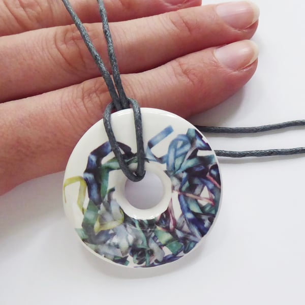 Tousled Ribbon Pattern Donut Shaped Ceramic Pendant on Grey Cord with Clasp