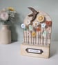 Wild Flower Garden with Bird in Wood and Clay