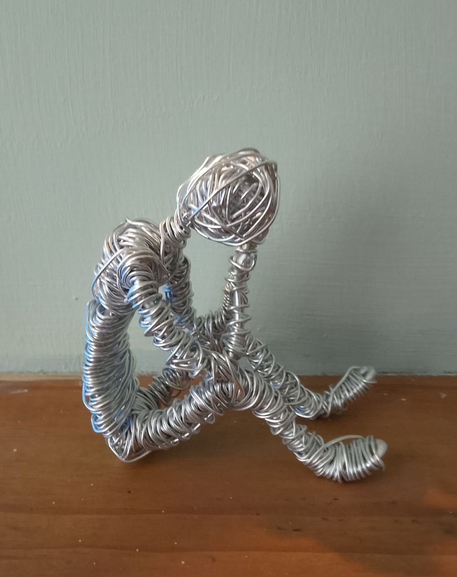 Thinking man made of wire 