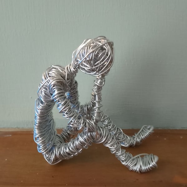 Thinking man made of wire 