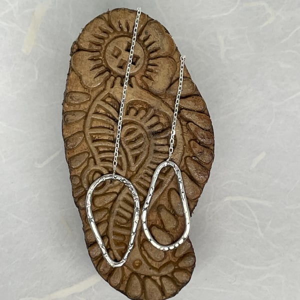 Asymmetrical hammered silver teardrop threaders.