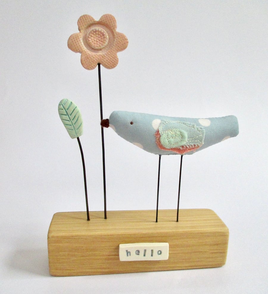 Handmade fabric bird with clay flower 'hello'