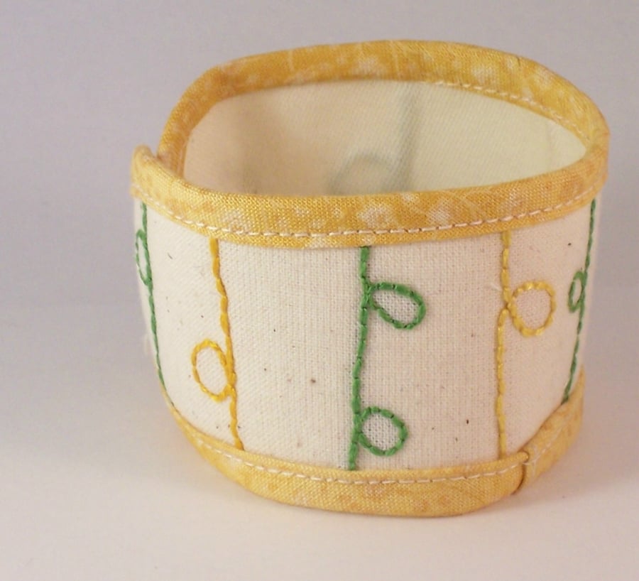 Hand embroidered textile jewellery cuff with vintage button