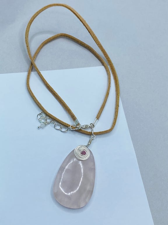 Oval rose quartz stone pendant on mocha coloured faux suede cord