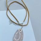 Oval rose quartz stone pendant on mocha coloured faux suede cord