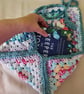 Crocheted book pouch or tablet case, wrap round fastening, multi-coloured