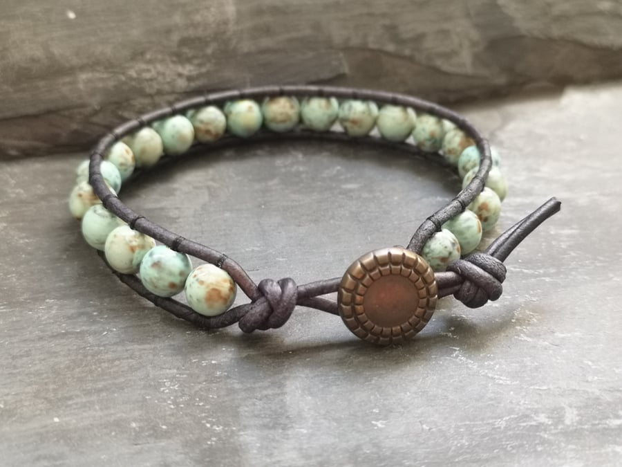 Leather bracelet with blue acrylic beads and copper button fastener