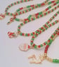 Red Gold and Green Bead Necklace with Gold Plated Enamelled Christmas Charms - Image 1