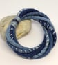 Felted cord bracelet in shades of denim blues