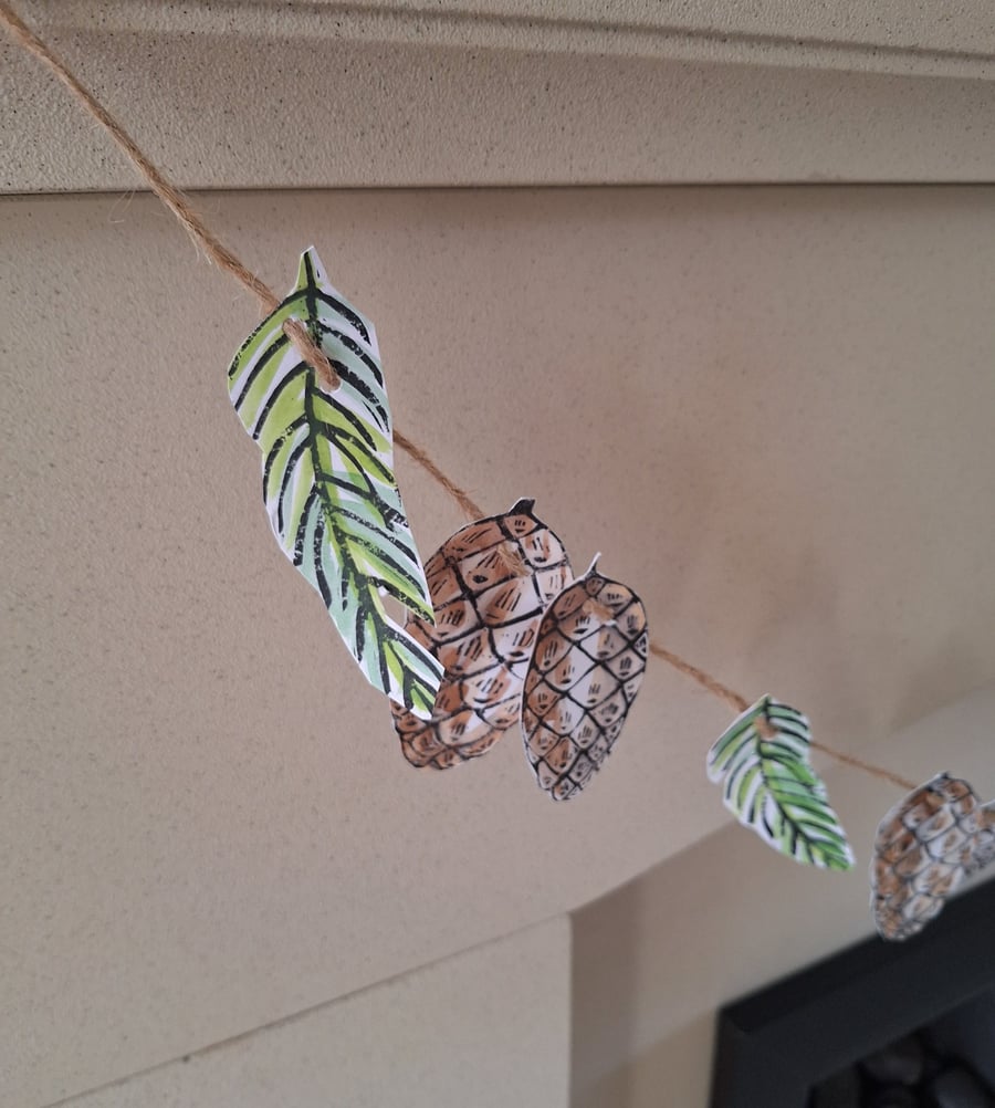 Linoprinted bunting of pinecones and pinesprigs