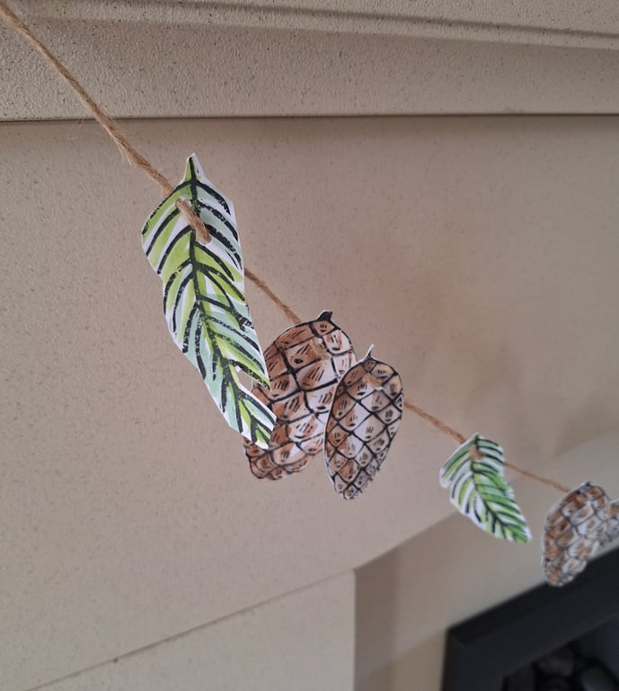 Linoprinted bunting of pinecones and pinesprigs