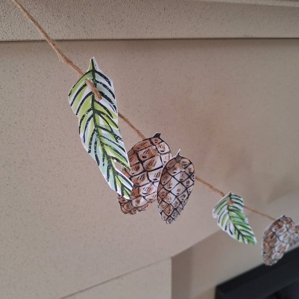 Linoprinted bunting of pinecones and pinesprigs