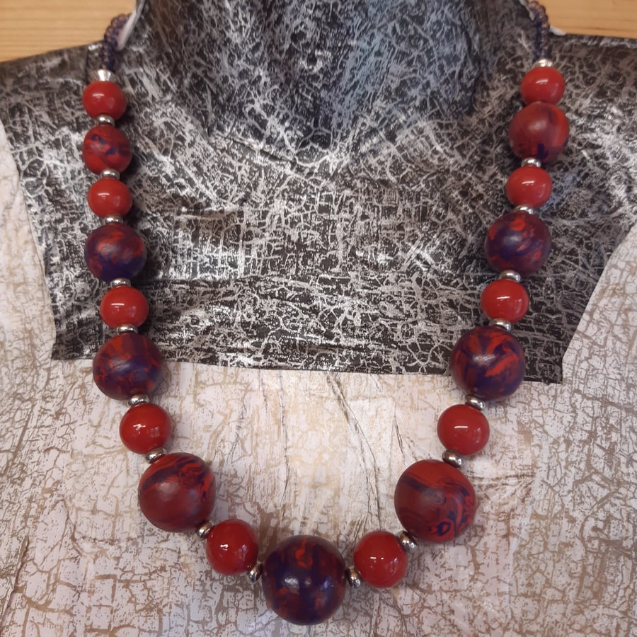 Necklace in a poppy red and purple swirl design