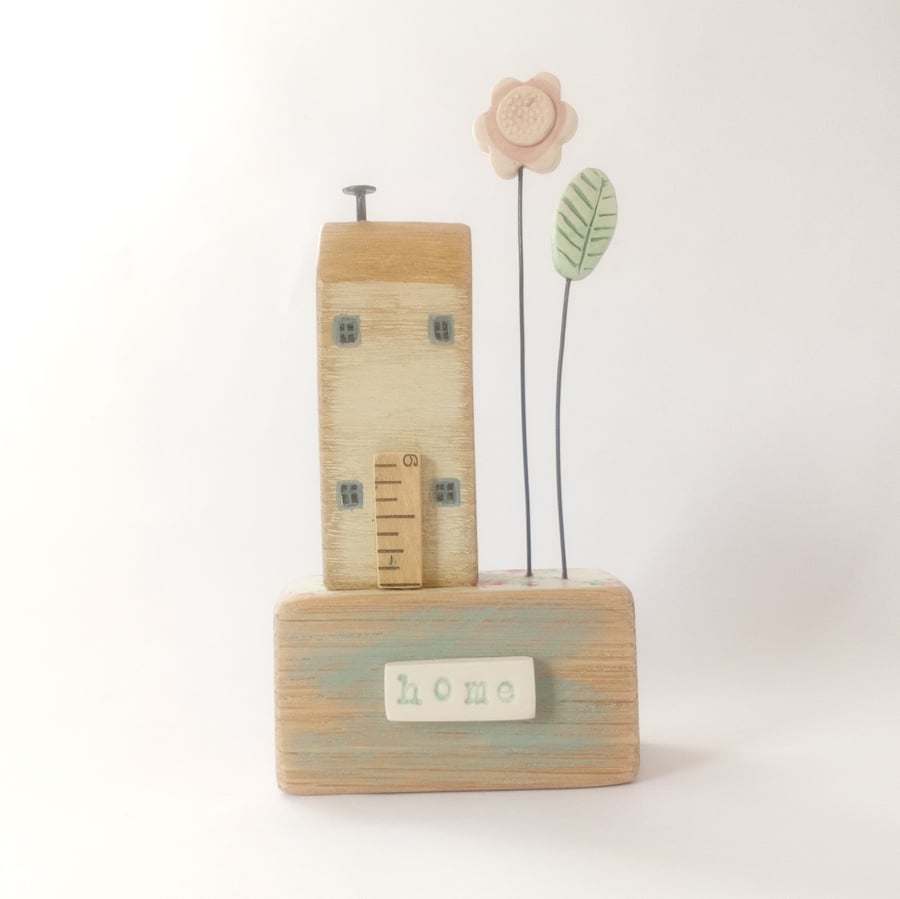 Wooden house with clay flower garden 'home'