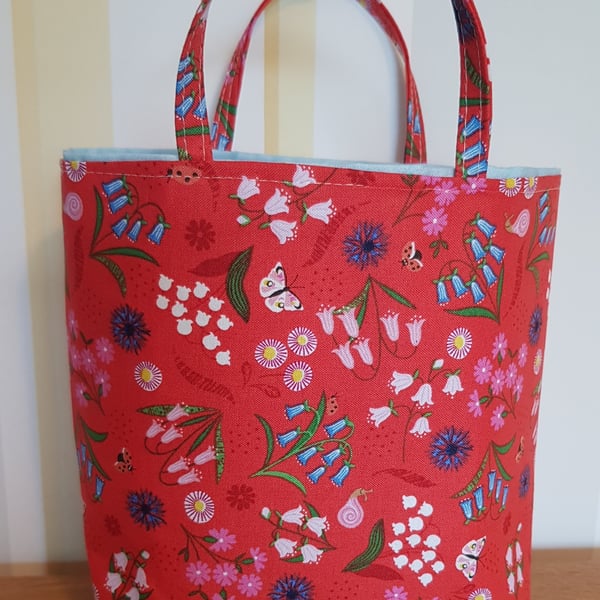 Reusable fabric gift bag: bluebells on red design 